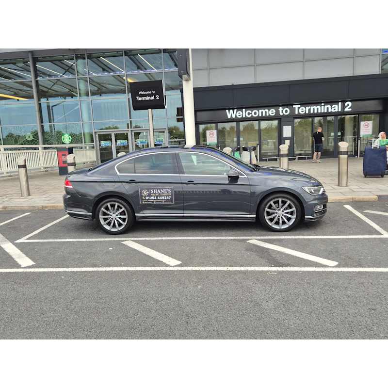 Shane's Airport Transfers Volkswagen Passat at an airport terminal